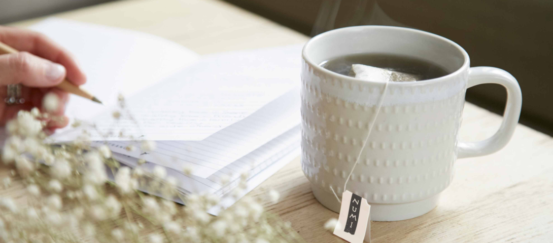 journal and tea cup with numi organic tea